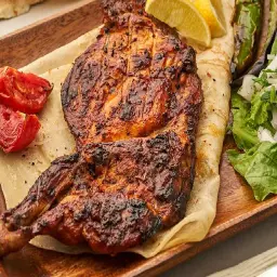 Half Grilled Chicken on Charcoal